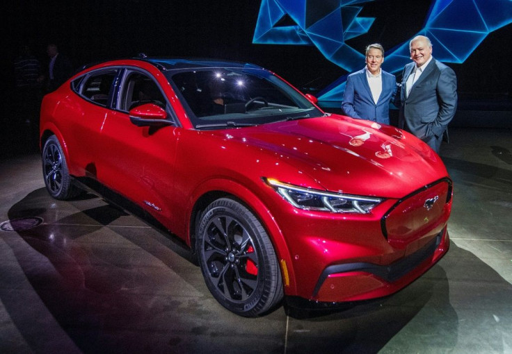 Ford CEO James Hackett (R) and a team member reveal the company's first mass-market electric car the Mustang Mach-E, which is an all-electric vehicle that bears the name of the company's iconic muscle car in Hawthorne, California on November 17, 2019