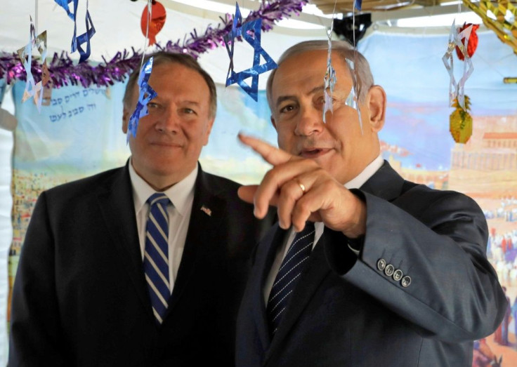 Israeli Prime Minister Benjamin Netanyahu (right) welcomes US Secretary of State Mike Pompeo to a sukkah, a temporary hut constructed to be used during the week-long Jewish festival of Sukkot, in Jerusalem in October 2019