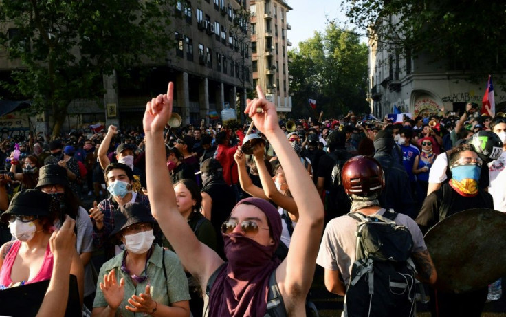 Demonstrators shout slogans during a protest against the government in Santiago on Monday