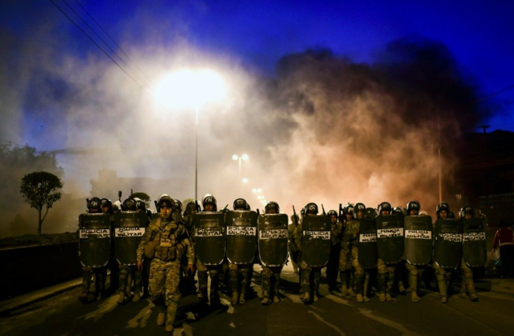 Bolivian police take position as supporters of Bolivian ex-President Evo Morales block a road in the outskirts of Sacaba, Chapare province, Cochabamba