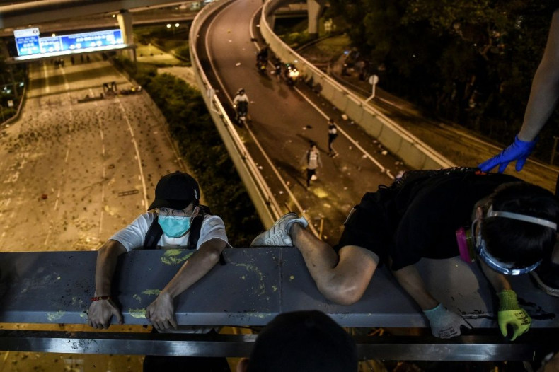 Pro-democracy protesters on a Hong Kong university campus under siege by police escaped by shimmying down a rope to waiting motorbikes