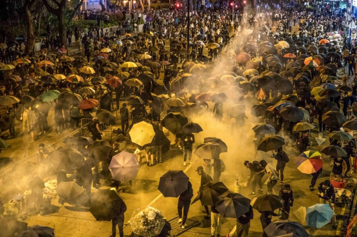 Protesters react as police fire tear gas while they attempt to march towards Hong Kong Polytechnic University