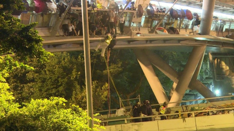 Dozens of Hong Kong pro-democracy protesters dramatically escape a police siege at a university campus by shimmying down ropes from a bridge to waiting motorbikes.