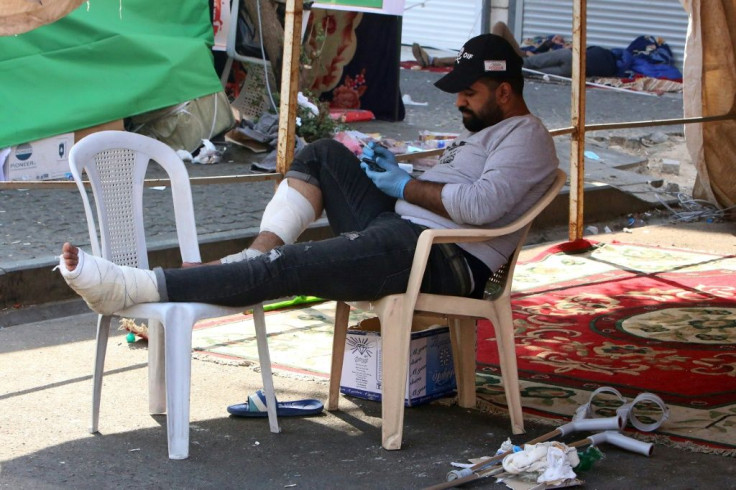 A wounded Iraqi protester rests under a tent in Al-Khalani square of central Baghdad