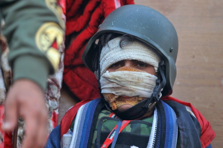 An injured Iraqi protester takes part in anti-government demonstration on Al-Ahrar bridge in Baghdad