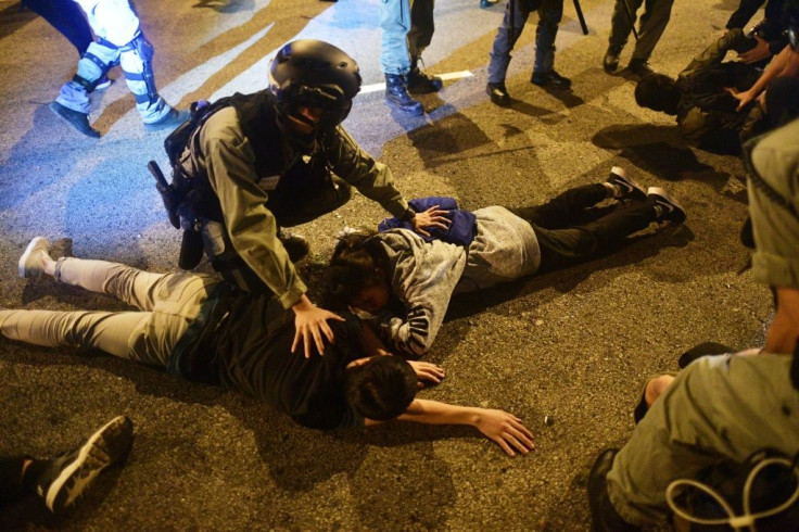 Police detain protesters and students after they attempted to escape from Hong Kong Polytechnic University campus and from police in the Hung Hom district of Hong Kong on November 19