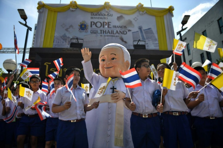 A costumed mascot and children yelling 'Sawadee Pa! (Hello Father)' greeted Pope Francis in Bangkok
