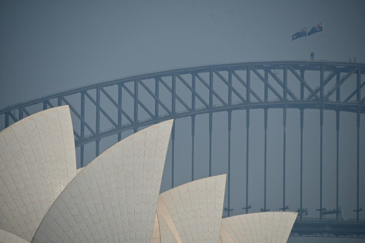 The Sydney Opera House and Harbour Bridge are seen through a smokey haze which blankets Sydney.