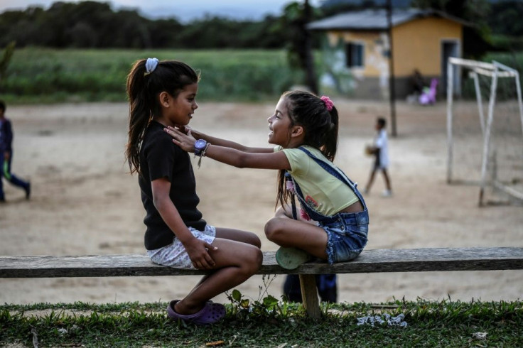 Two girls, the daughters of former FARC rebels, play in the municipality of La Montanita
