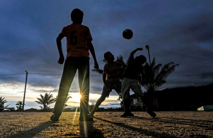 Children play football in the municipality of La Montanita