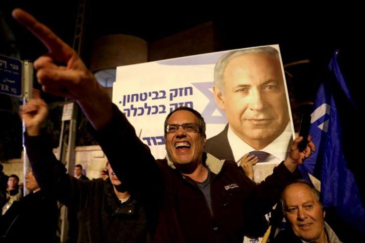 Supporters of Israeli Prime Minister Benjamin Netanyahu chant slogans in solidarity with the premier nicknamed "King Bibi"
