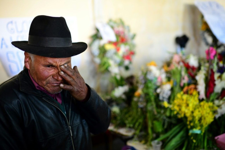 A man mourns during the funeral of eight supporters of Bolivia's ex-President Evo Morales, killed when security forces lifted a siege on a fuel plant, in El Alto on November 21, 2019Bolivia's interim President Jeanine Anez asked Congress Wednesday to ap