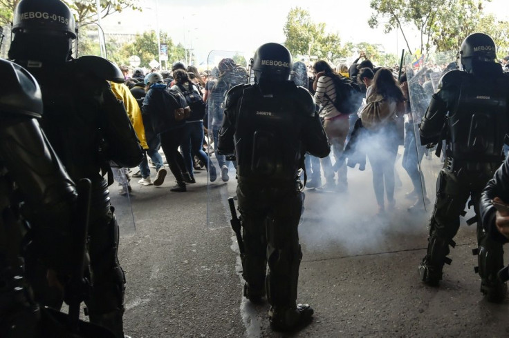 Riot police fire tear gas to disperse demonstrators in Bogota during a nationwide strike