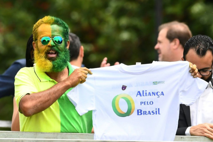 A supporter of Brazilian President Jair Bolsonaro holds a t-shirt during the launch of Bolsonaro's new party, the Alliance for Brazil, at a hotel in Brasilia