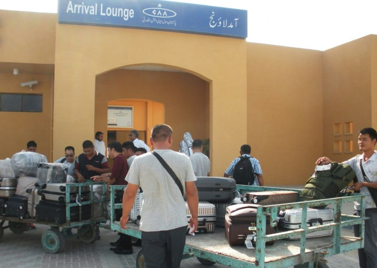 Chinese nationals wait to receive luggage in October 2017 after arriving at Pakistan's Gwadar port, which is undergoing a major redevelopment funded by Beijing