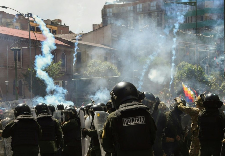 Riot police fire tear gas at supporters of former Bolivian president Evo Morales in La Paz on November 21, 2019