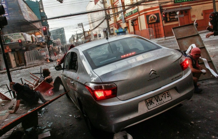 A car runs over demonstrators protesting against the government of Sebastian Pinera in Antofagasta, Chile on November 21, 2019