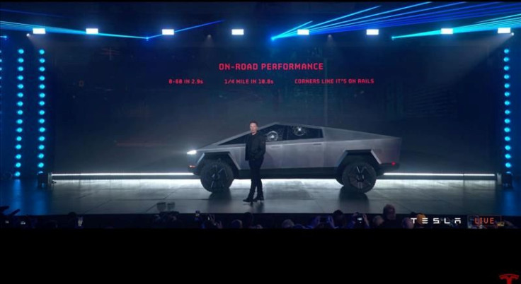 Tesla Chief Executive Elon Musk stands in front of the company's first electric pickup truck, the Cybertruck, after it was unveiled in Los Angeles