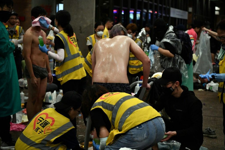 Anti-government protesters sprayed by pepper-water and teargas being treated by volunteer medics the Polytechnic University of Hong Kong