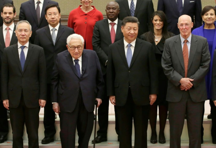China's President Xi Jinping (2nd R), Vice Premier Liu He (L), former US Secretary of State Henry Kissinger (2nd L), former US Treasury Secretary Henry Paulson (R) and other members of a delegation