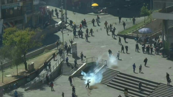 IMAGESBolivian riot police fire tear gas to break up a massive funeral procession that turned into an anti-government demonstration as Congress debated when to hold new elections.