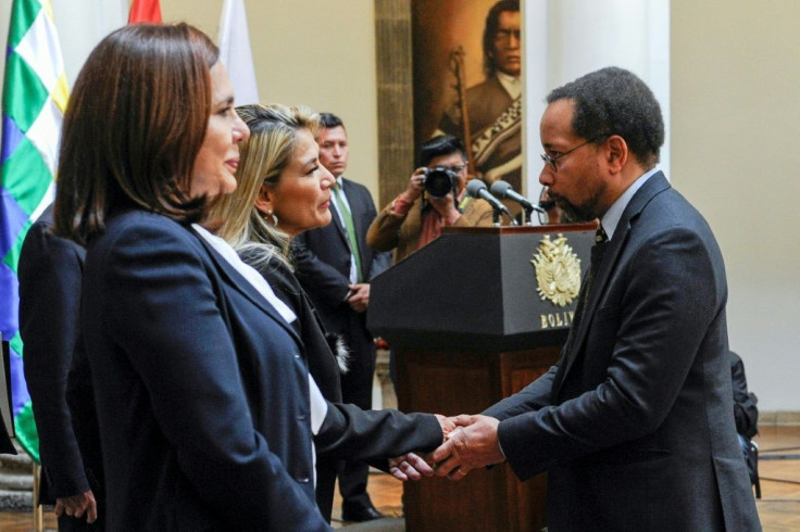 Anez (2-L) is greeted by the US Charge d'Affaires in Bolivia, Bruce Williamson at Quemado presidential palace in La Paz on November 22, 2019