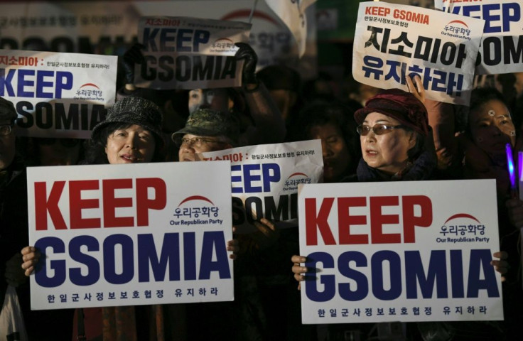 Pro-US activists clutch signs at an anti-government rally demanding an extension of the General Security of Military Agreement outside the US embassy in Seoul
