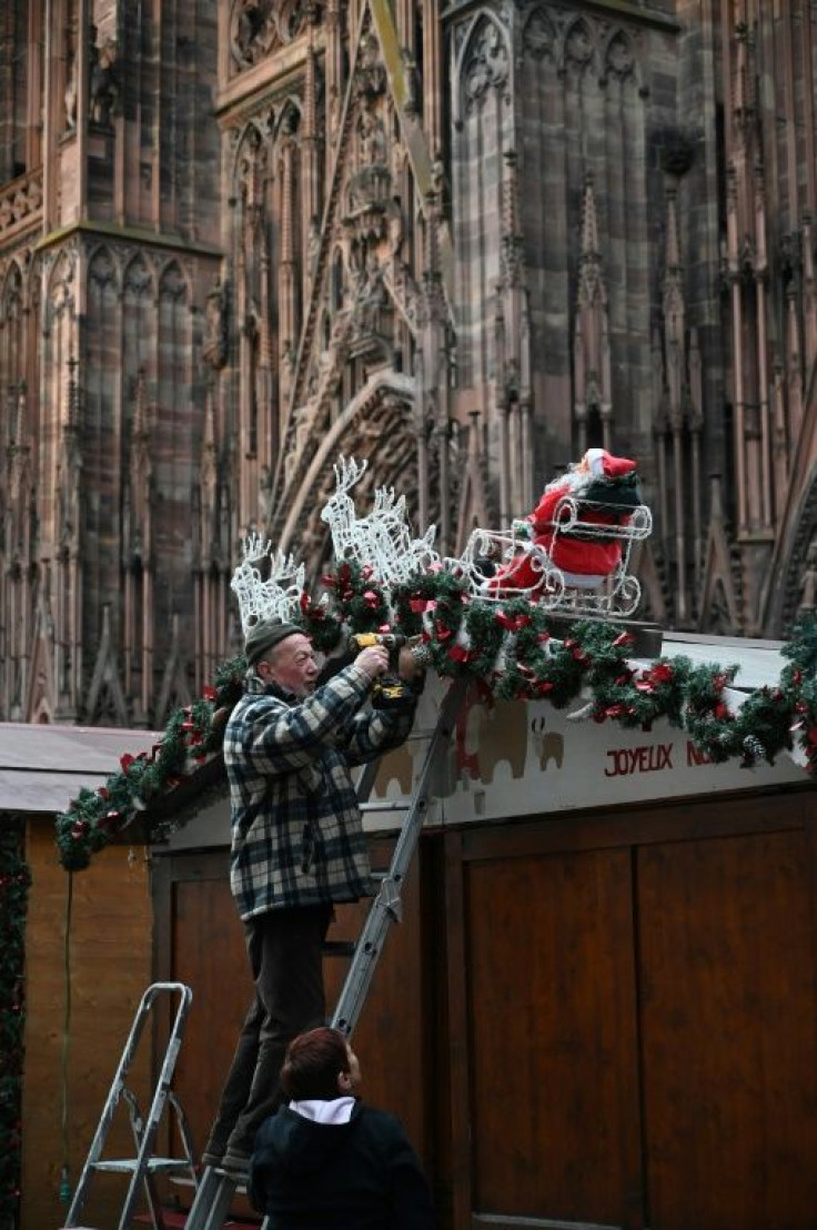 A worker installs decorations at the market, which will see a beefed up security presence this year