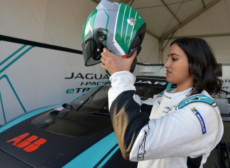 Saudi Arabia's first woman racing driver Reema al-Juffali adjusts her helmet in front of her car