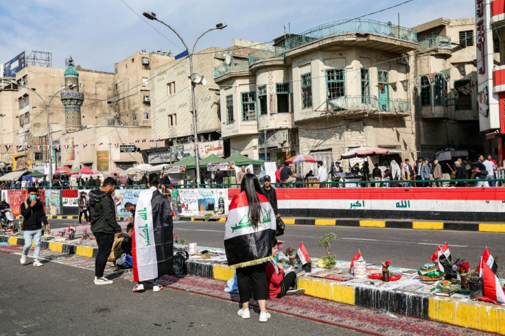 Protesters read from the Holy Koran in the Iraqi capital's Tahrir Square on November 23, 2019