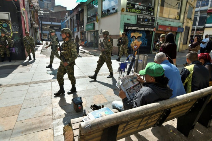 Soldiers patrol the streets of Bogota after a curfew imposed to stop looting is lifted