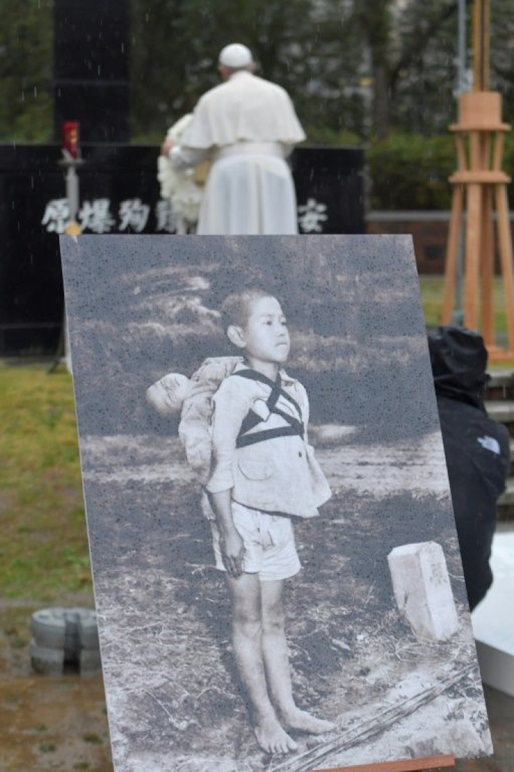 Pope Francis spoke while standing next to a photo of a young boy carrying his dead baby brother on his back in the aftermath of the Nagasaki nuclear bomb attack