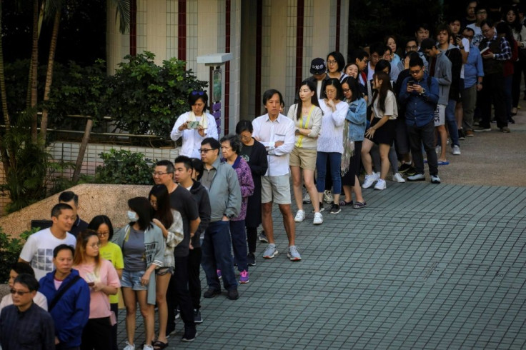 Voters line up to cast their ballot in Hong Kong's district council elections