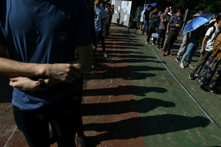 Mainland China media urged Hong Kongers to vote for establishment figures in district elections, but a record turnout is likely to benefit pro-democracy forces