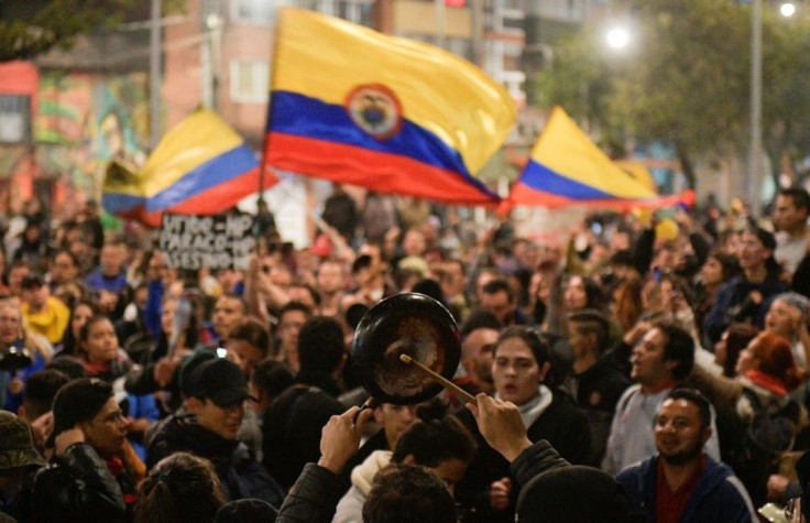 People take part in a protest against the government of Colombia's President Ivan Duque, in Bogota, on November 23