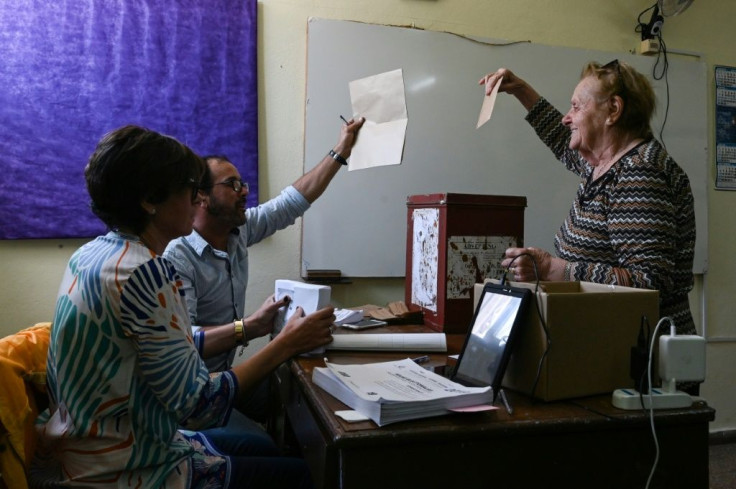 Polling station workers in Canelones check ballots during Uruguay's run-off presidential election