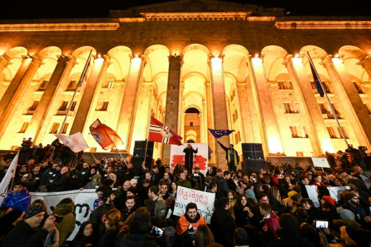 Protesters demanding the government's resignation and early parliamentary polls rally in front of the parliament in Tbilisi