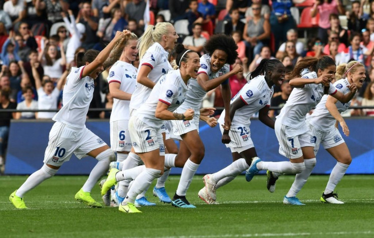 Lyon's players celebrate after winning the "Trophee des Championnes" in 2019
