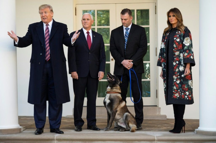 US President Donald Trump, Vice President Mike Pence and First Lady Melania Trump, pictured with Conan, the military dog involved in the US raid that led to the death of Islamic State group leader Abu Bakr al-Baghdadi