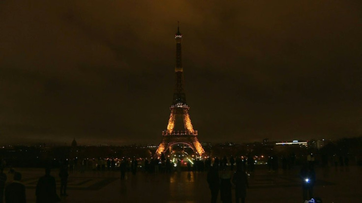 The lights of the Eiffel Tower are switched off for one minute at midnight to mark the International Day for the Elimination of Violence against Women