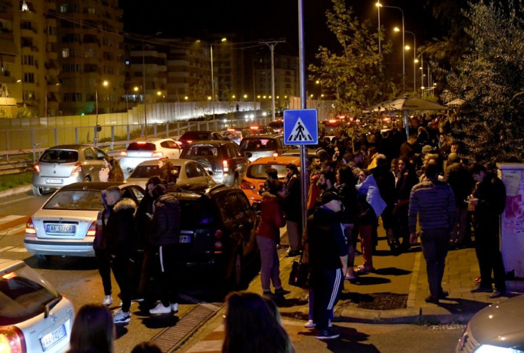 Residents gathered outdoors in Tirana