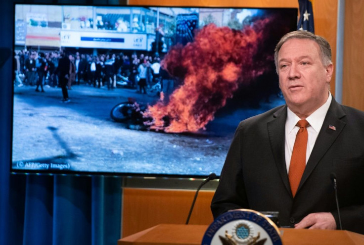 US Secretary of State Mike Pompeo speaks alongside a photograph of demonstrations in Iran