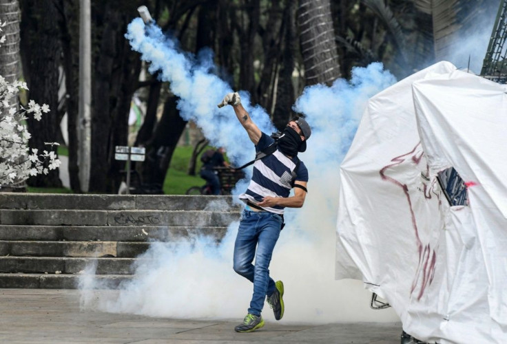 Demonstrators confront riot police during a protest against the government of Colombian President Ivan Duque, in Bogota, on November 23, 2019