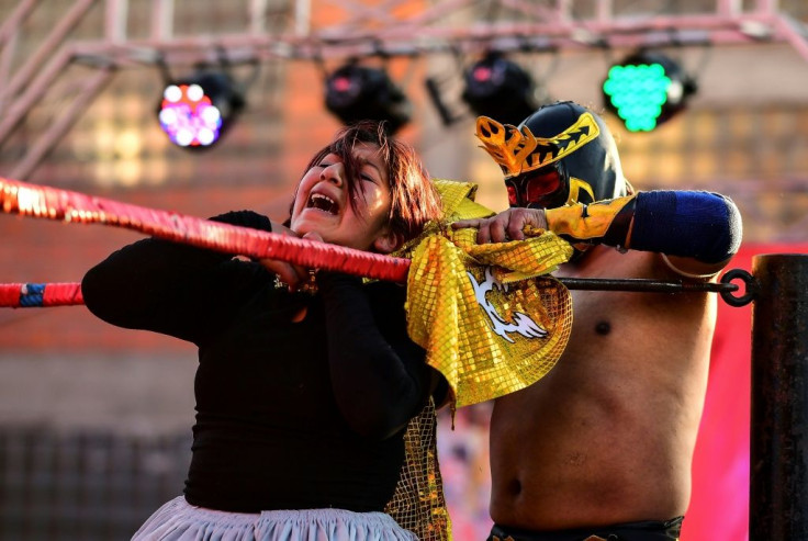 Blanca Perez (L), aka "Katy The Beautiful," struggles to free herself from a neck hold