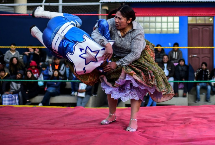 Ana Luisa Yujra, aka "Jhenifer Two Faces", slams a male wrestler