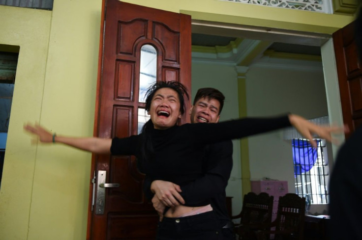 Relatives grieve as the casket bearing the body of Nguyen Van Hung arrived home in Dien Chau district, Nghe An province