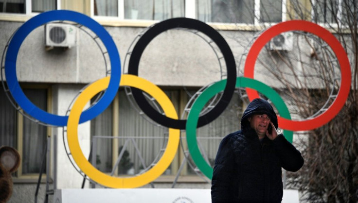A man talks on his mobile phone in front of the Russian Olympic Committee (ROC) headquarters in Moscow