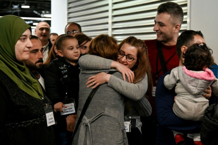 Host families and volunteers greeted the new arrivals -- some of them family members -- with smiles and tears