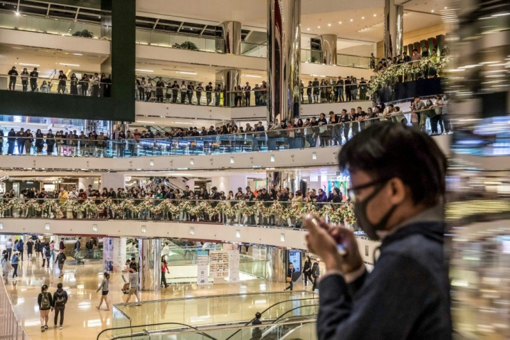 Pro-democracy protesters chant slogans in a shopping mall in Hong Kong on November 27, 2019