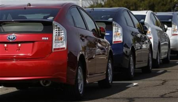 Toyota Motor Corp`s newest Prius hybrid car goes in front of the building of the company headquarters